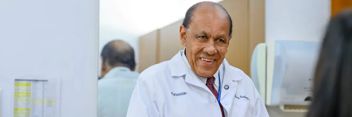 Breast surgeon Henry Godfrey talks with a patient at MSK’s Ralph Lauren Center