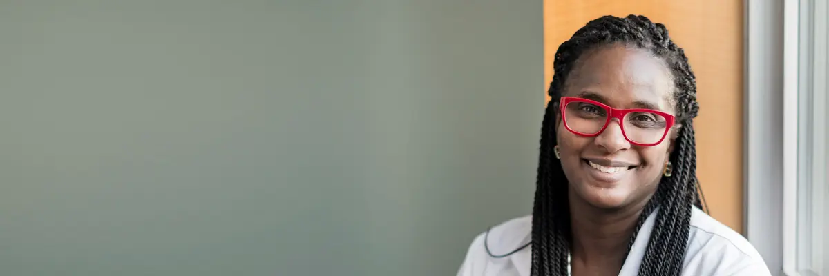 MSK clinical trials nurse Asia McCoy, in a white lab coat. 