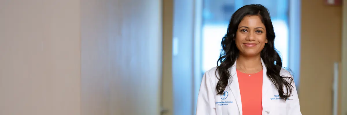 Gastrointestinal medical oncologist Dr. Smita Joshi stands in a hallway posing for a photo. 