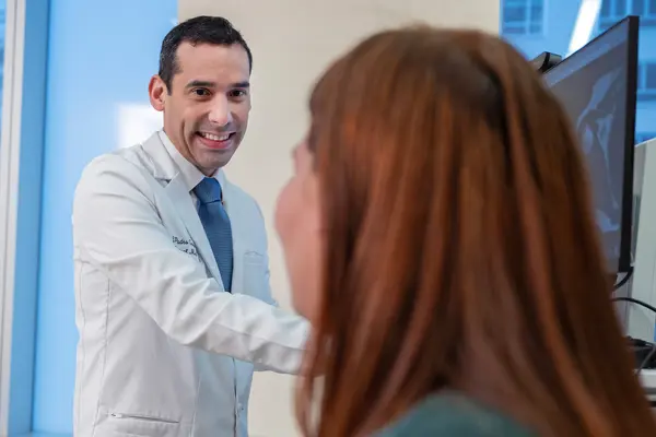Rehabilitation medicine doctor Jesuel Padro-Guzman is with his patient at MSK in New York City.  
