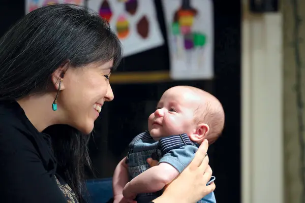 Stage 3 rectal cancer survivor Dana Vergara is smiling as she holds her baby boy, Hudson. 