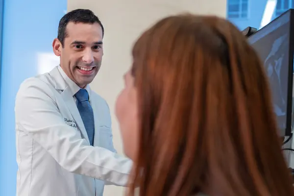 Rehabilitation medicine doctor Jesuel Padro-Guzman is with his patient at MSK in New York City.  