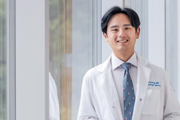Head and neck medical oncologist Dr. Michael Hwang talks with his patient at MSK in Commack on Long Island. 