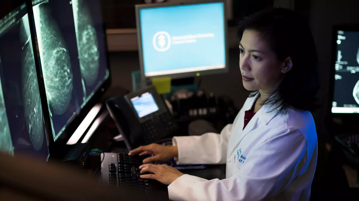 Radiologist Dr. Kristin Belen looks at breast imaging on screens 