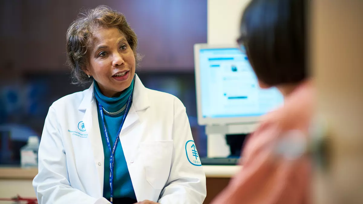 Medical oncologist Diana E. Lake, an expert in breast cancer, talks with a patient  