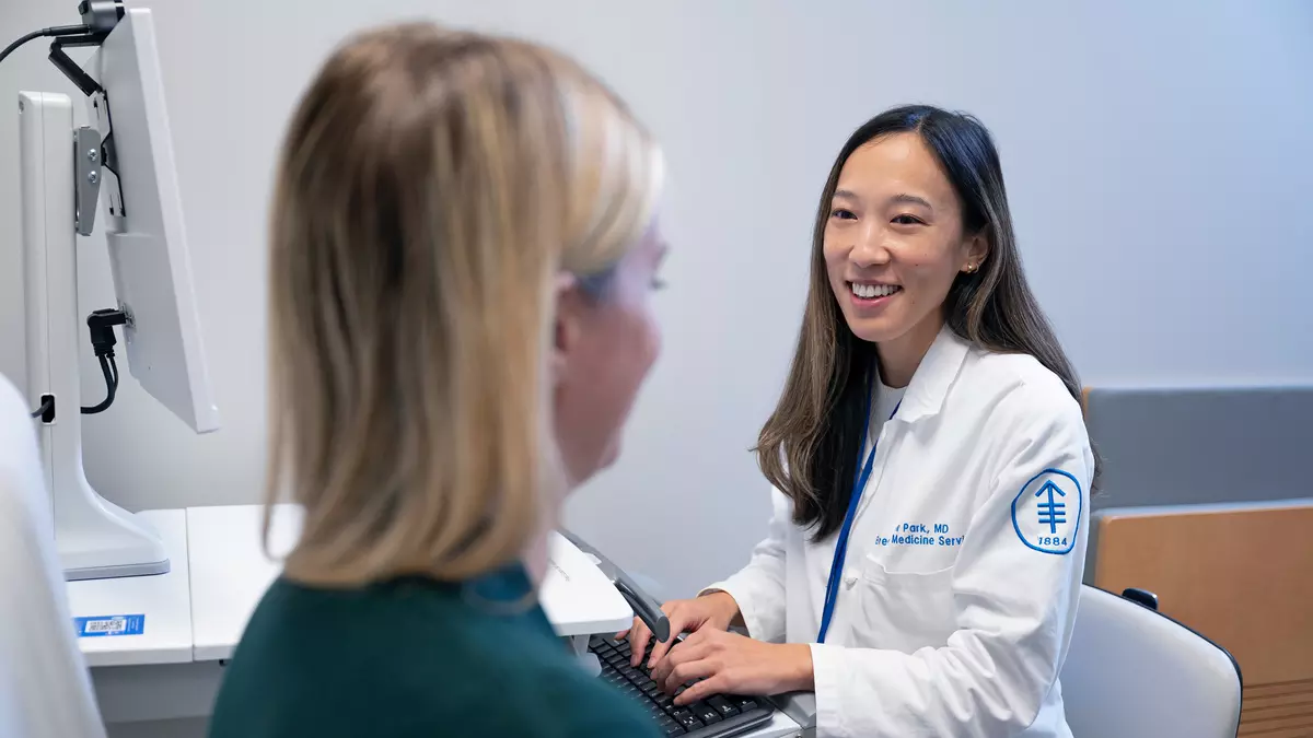 Breast oncologist Sue Park is with a breast cancer patient 