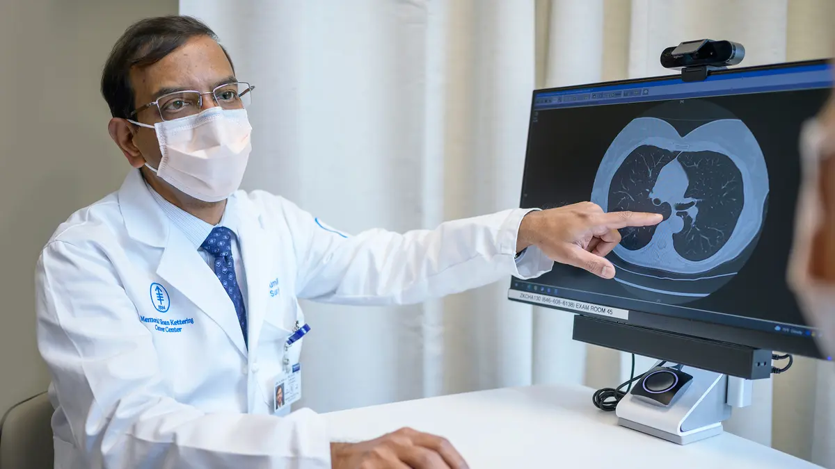 Thoracic surgeon Dr. Prasad S. Adusumilli with a computer showing an image of a lung scan.