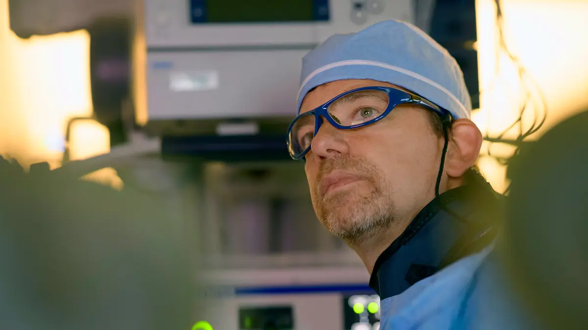 Gastroenterologist Dr. Mark A. Schattner is in scrubs and doing a colon cancer screening test.