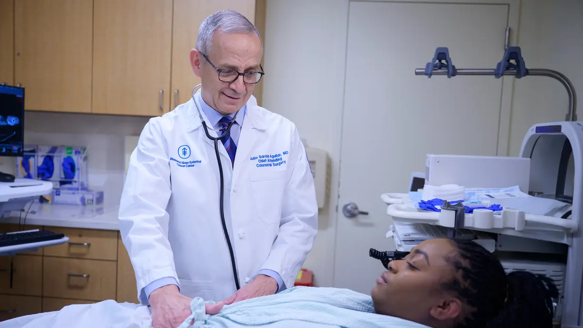 Colorectal surgeon Dr. Julio Garcia-Aguilar is examining an MSK patient who is lying on an exam table. 
