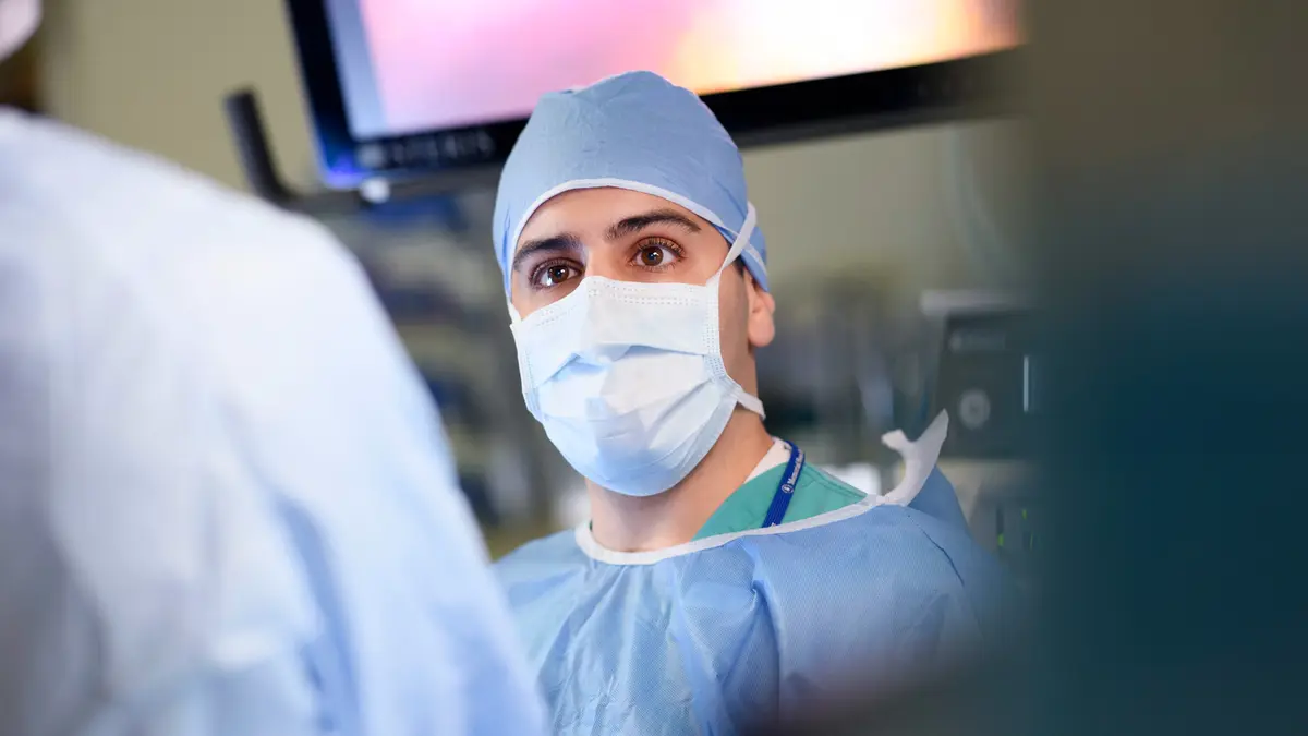 Colorectal surgeon Dr. Emmanouil P. Pappou, dressed for surgery, is an expert in robotic surgery.  