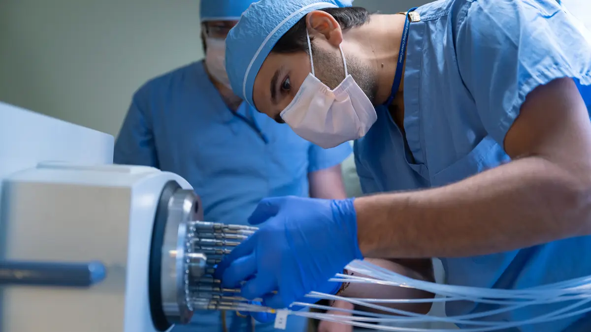 Medical physicist David Aramburu Nunez connects tubes in MSK’s brachytherapy suite.  