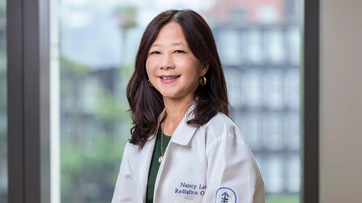 Radiation oncologist Dr. Nancy Lee, at MSK in New York City, in a white doctors’ coat. 