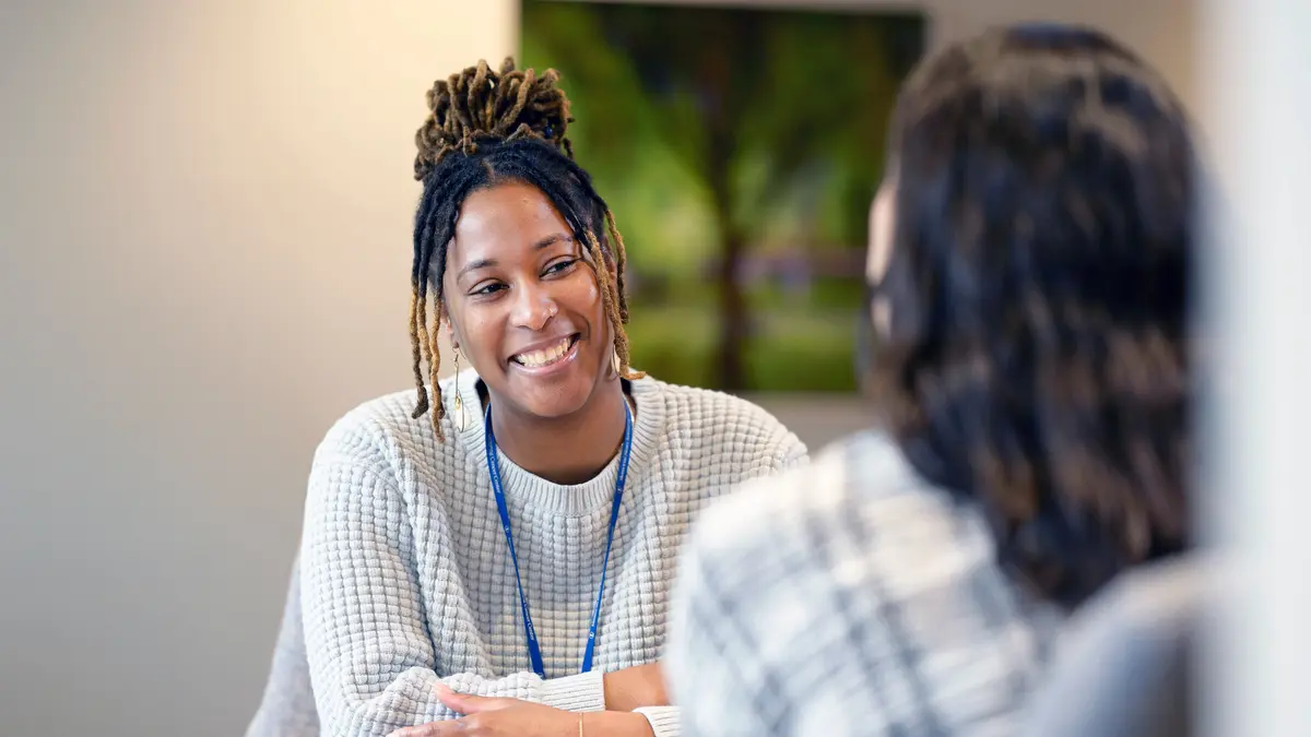 Clinical social worker Estina Cain smiles as she talks with her patient.   
