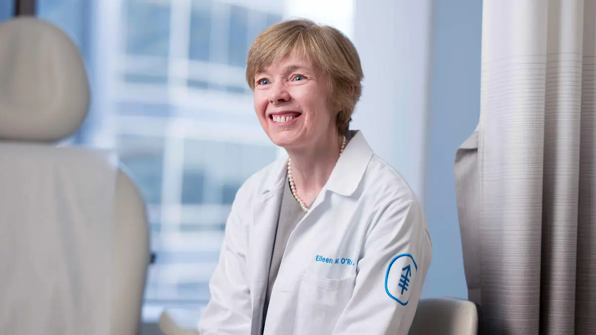Dr. Eileen O'Reilly seen smiling in an exam room.