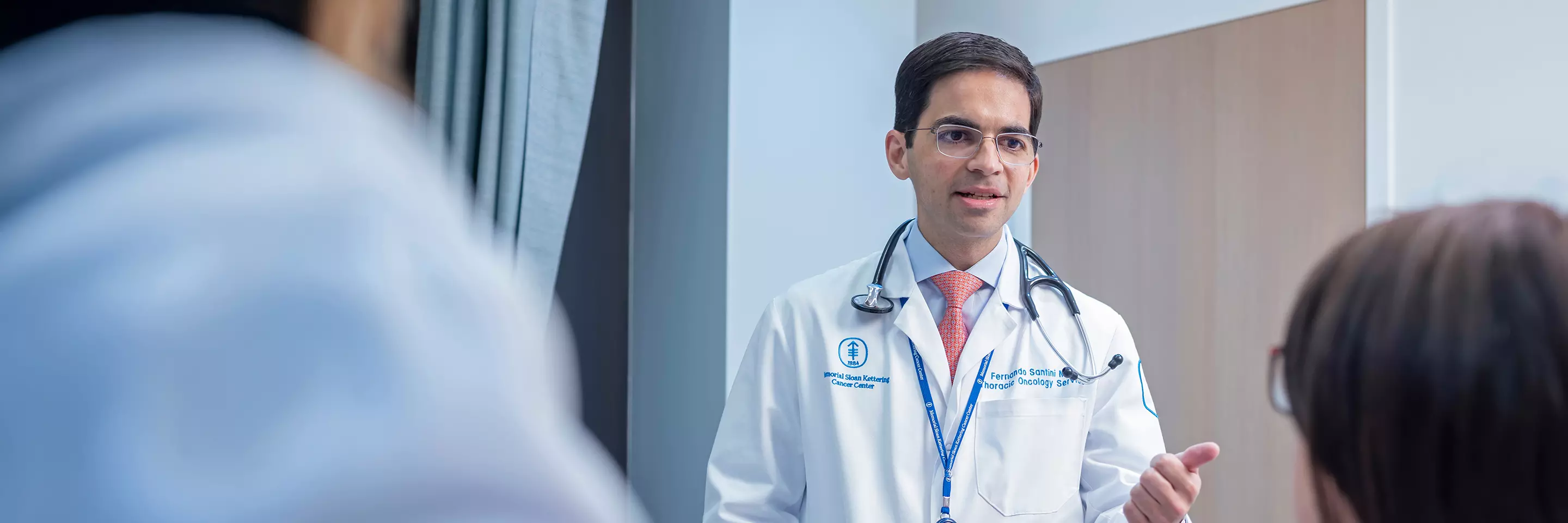 Thoracic medical oncologist Dr. Fernando Santini is with a patient.